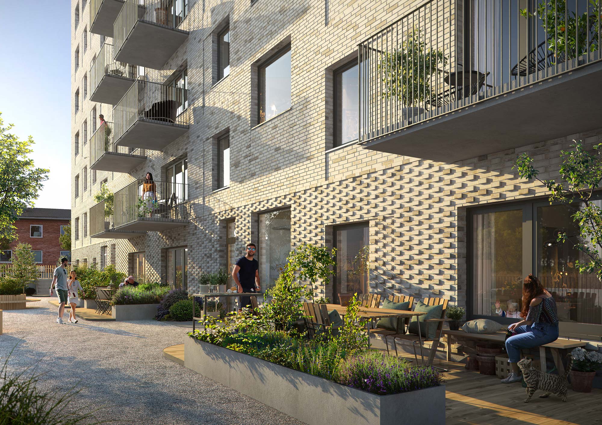 Shared courtyard at Karlavagnen, Skellefteå Shared green courtyard at Karlavagnen in Skellefteå, with planted beds, timber deck and outdoor dining furniture