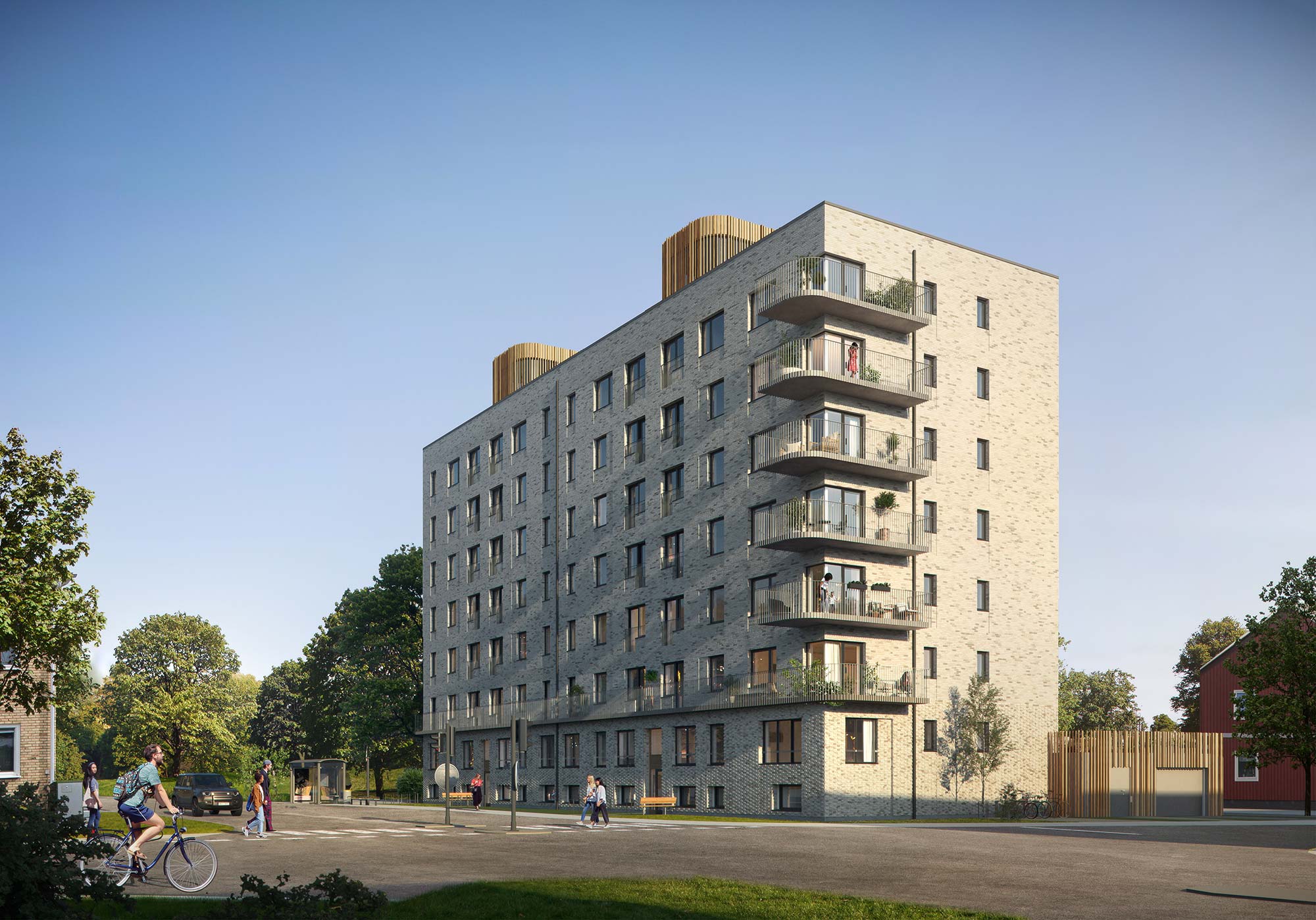 Karlavagnen, Skellefteå — new-build serviced apartments for corporate stays Street view of the new-build apartment building at Karlavagnen in Skellefteå, with pale brick facade, balconies and a bus stop outside